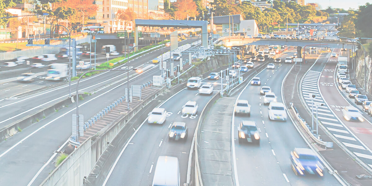 Vehicles driving down a busy road in New South Wales