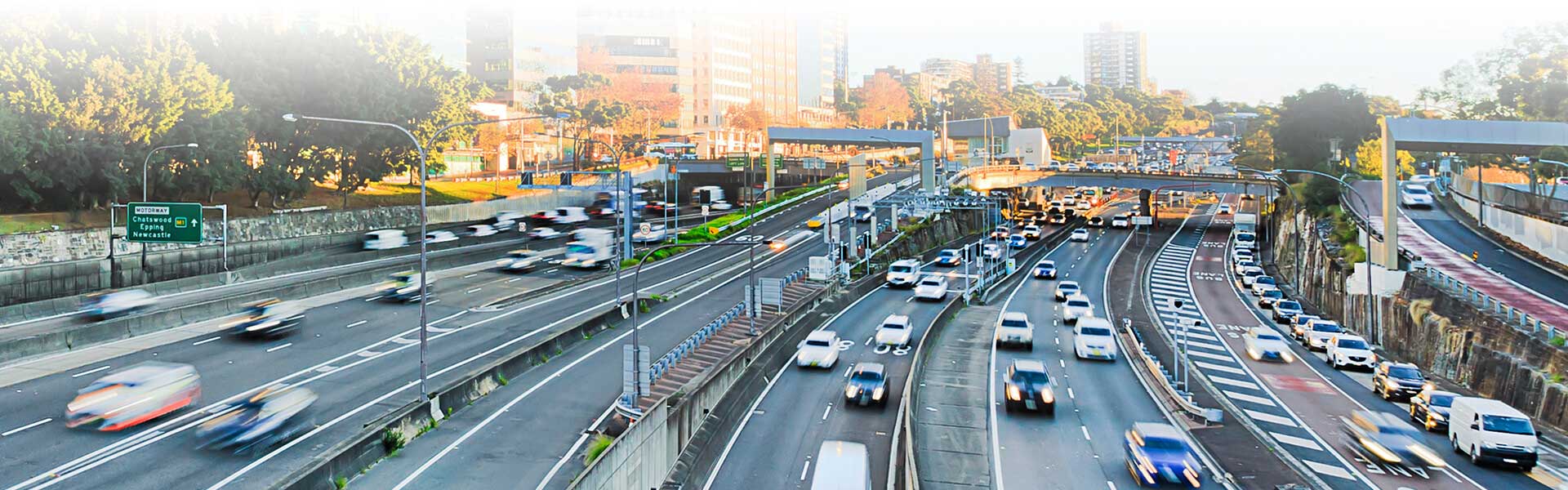 Vehicles driving down a busy road in New South Wales