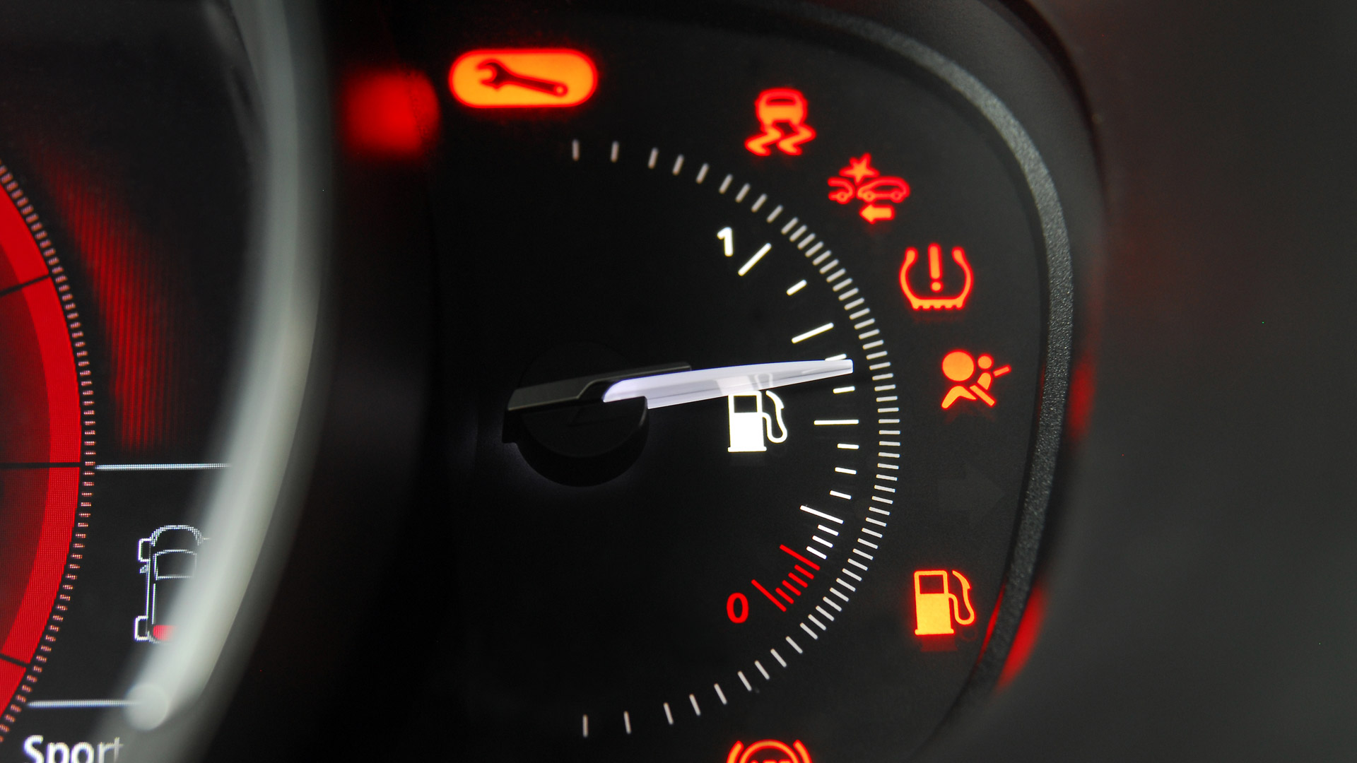 The fuel gauge of a car sitting at half full