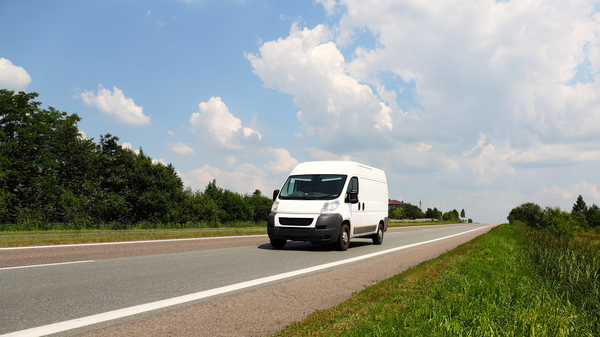 A white van driving down a road