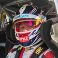 close up of Garth tander in vehicle with fleetcare logo on the helmet 