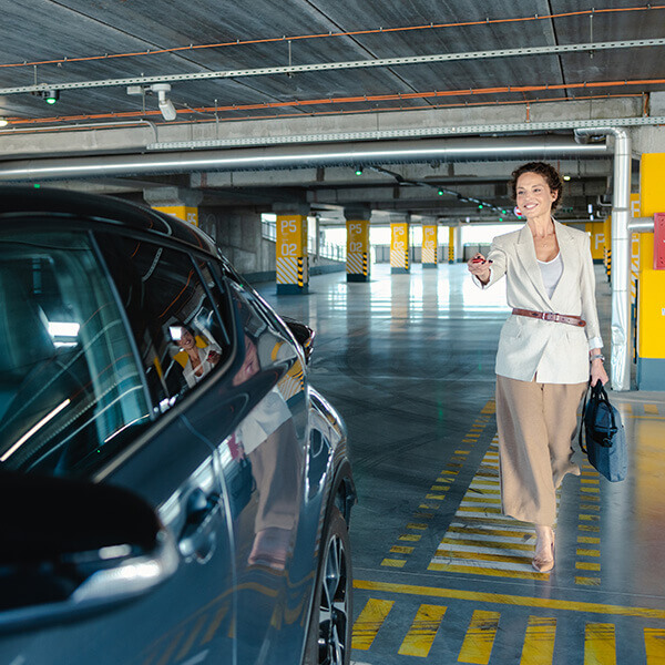 Business person unlocking their car