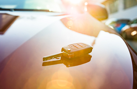 car keys laying on red car 