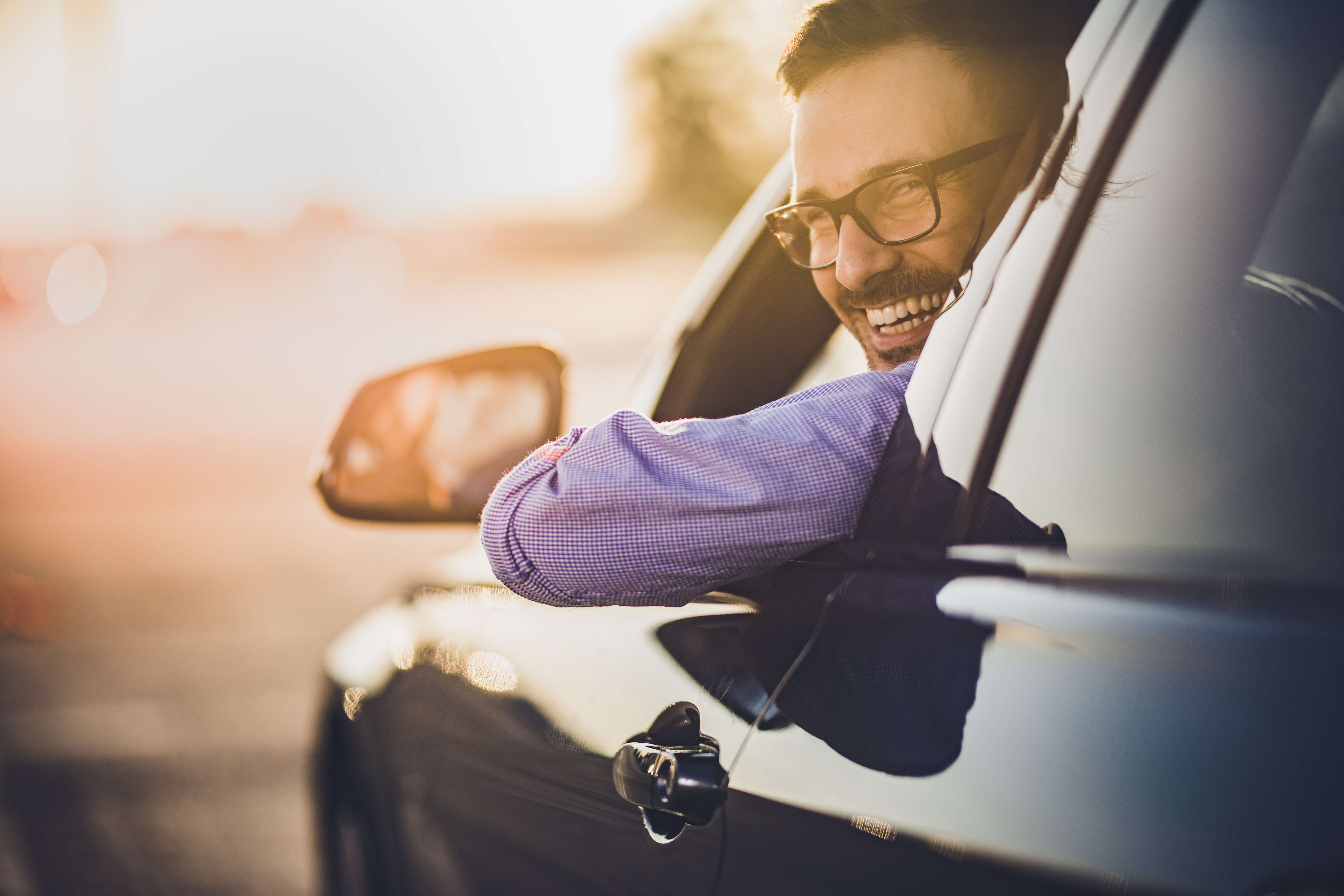 a man looking out of his car