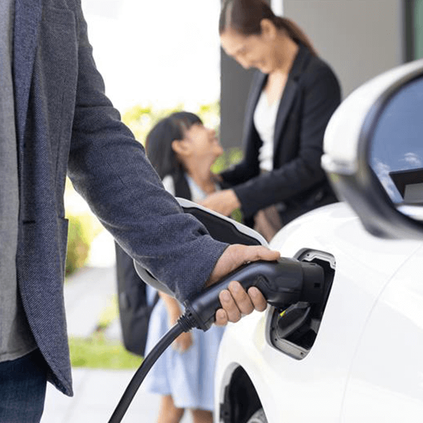 Person charging Electric Vehicle